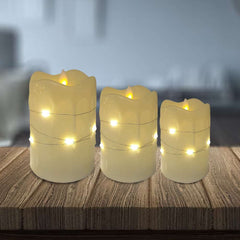 Flameless LED pillar candles with string lights.