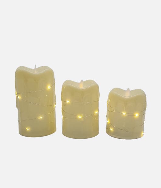 Flameless LED pillar candles with string lights.