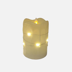 Flameless LED pillar candles with string lights.